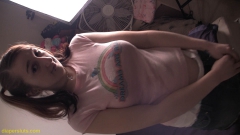 Samara taking off her pants to show off her new diaper