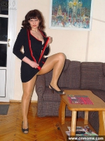Mature sleek woman undressing and posing
