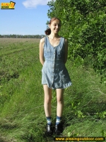 Pissing outdoor on a green grass