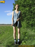 Pissing outdoor on a green grass