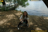 Pissing outdoor on pond beach