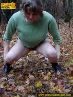 Pissing outdoor on dried leaves on a ground