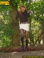 Pissing outdoor on a fallern trunk