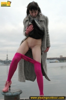Outdoor pissing on embankment by MILF brunette