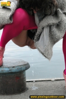 Outdoor pissing on embankment by MILF brunette