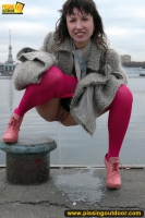 Outdoor pissing on embankment by MILF brunette