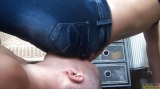 Sitting on face of slave while wearing jeans