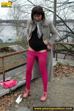 MILF brunette pissing on concrete lookout - N