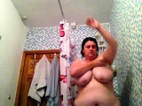 Busty brunette takes a shower with water on boobs